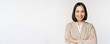Leinwandbild Motiv Confident female entrepreneur, asian business woman standing in power pose, professional business person, cross arms on chest, standing over white background