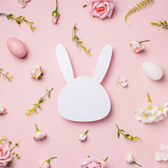 Wall Mural - Easter bunny head shape surrounded with colored eggs and fresh flowers on pastel pink background. Minimal Easter concept. Traditional spring holiday greeting card or banner with copy space for text.