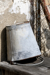 Closeup of a steel bucket on a wooden surface