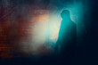 A moody hooded figure, at night, back to camera. Silhouetted against lights. With a neon grunge edit