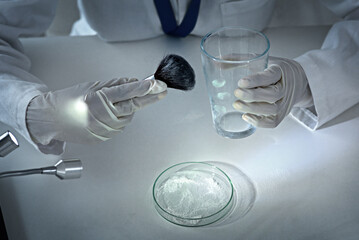 Poster - Dusting for prints. High angle shot of an unrecognizable female forensic scientist dusting for prints in the lab.