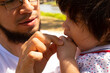 © Antonio Tanaka - portrait of a Hispanic father and baby in a park smiling and having fun