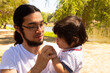 © Antonio Tanaka - portrait of a Hispanic father and baby in a park smiling and having fun