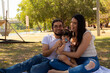 © Antonio Tanaka - Young Hispanic parents playing with their one year old baby in a park