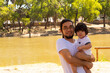© Antonio Tanaka - portrait of a Hispanic father and baby in a park smiling and having fun
