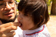 © Antonio Tanaka - portrait of a Hispanic father and baby in a park smiling and having fun