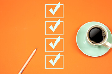 marking on checklist box. Checklist concept, pink pencil with cup of coffee on orange background