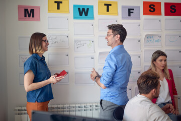 Wall Mural - Young colleagues in the office are discussing about job. Employees, job, office