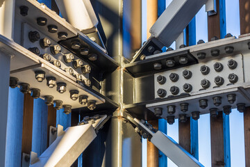 Detail of steel screw bolts connecting massive industrial steel construction