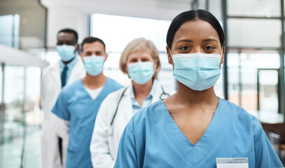 Sticker - As medical professionals, we have such an important job to do. Portrait of a group of medical practitioners wearing face masks while standing together in a hospital.