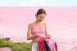 © Pixel-Shot - Young tourist with backpack near pink lake