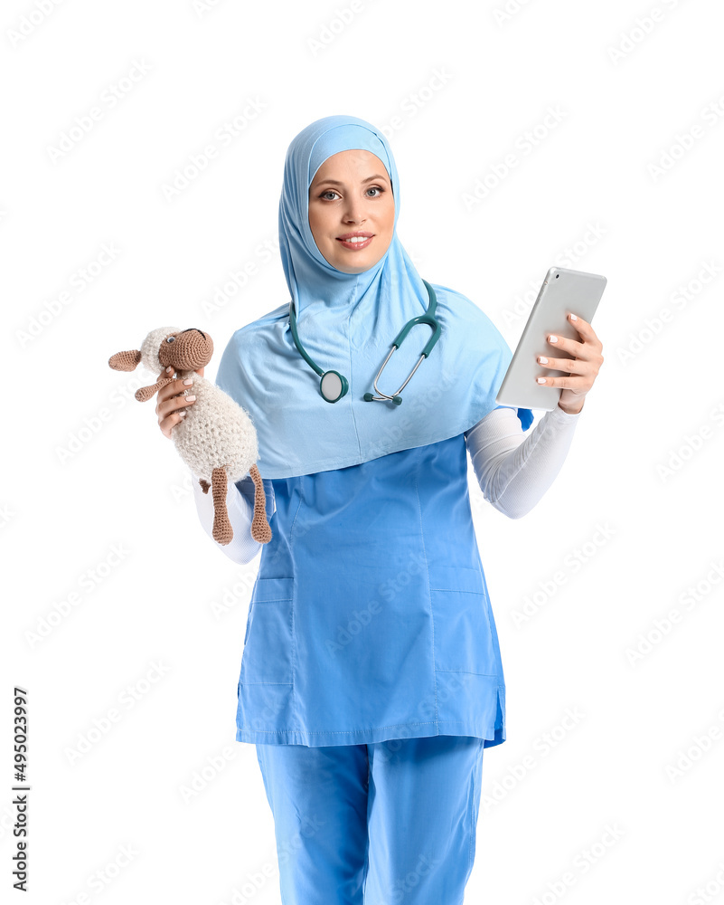Muslim pediatrician with tablet computer and toy on white background