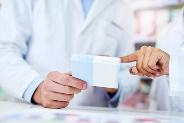 Wall Mural - Teamwork makes the treatment work. Cropped shot of a man and woman discussing medication while working at a pharmacy.