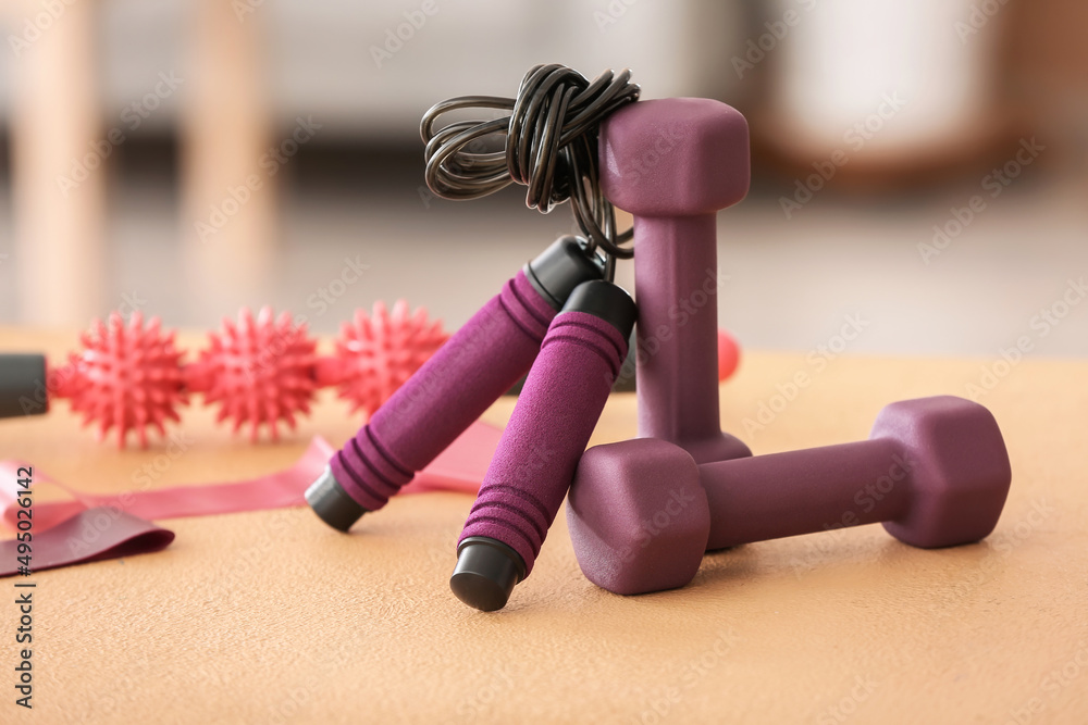 Stylish sport equipment on table in room, closeup