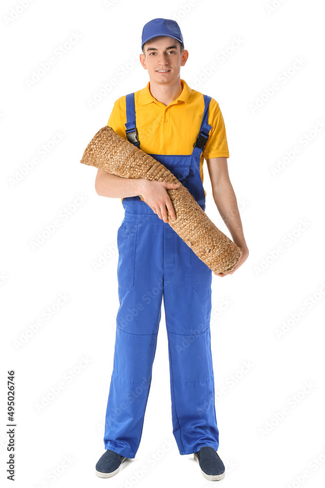 Male worker with rolled carpet on white background
