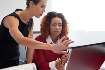 Poster - They work well together. Shot of two businesswoman working together at a computer in an office.