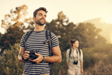 Sticker - Nothing makes you feel as good as the outdoors. Shot of a man out hiking with his girlfriend following in the background.