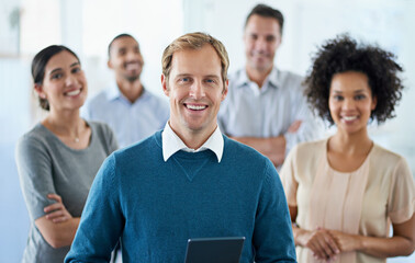 Wall Mural - My team can achieve anything. Portrait of a group of diverse colleagues standing in an office.