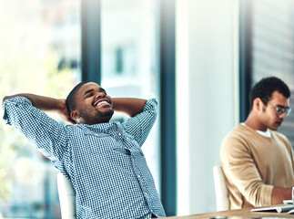 Poster - Its feels good to be good at your job. Shot of a young designer looking relaxed at his desk.