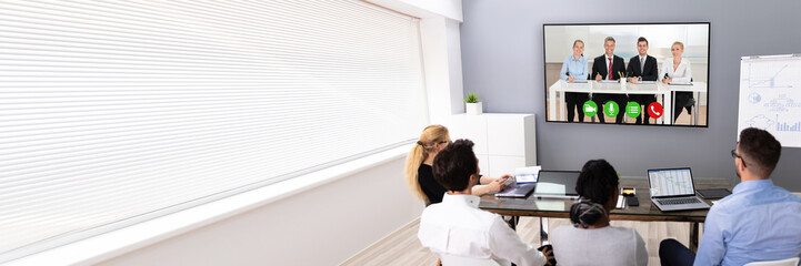 Poster - Businesspeople Discussing Graphs Through Videochat