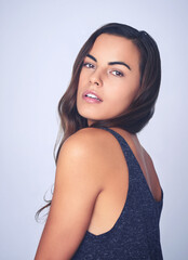 Poster - Being beautiful comes naturally to her. Studio shot of a beautiful young woman posing against a purple background.