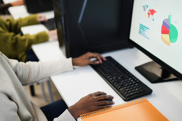 Hands view of young african student using computer inside college room at school university - Focus on right hand