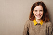 © contrastwerkstatt - young happy smiling business woman against brown background