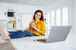 © contrastwerkstatt - young modern business woman taking a break in the office and holding a cup in her hand