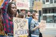 © MandriaPix - Young African woman in a group of demonstrators in city streets, multiracial people protesting for equality and empowerment, feminism protest