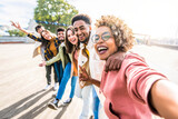 Multiracial friends group taking selfie pic with smartphone outside - Happy young people having fun walking on city street - Friendship concept with guys and girls enjoying summertime day outside