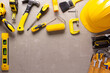 Construction tools at grey concrete background