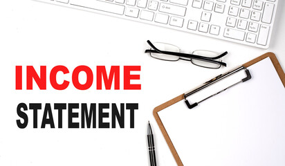 Poster - INCOME STATEMENT text written on the white background with keyboard, paper sheet and pen