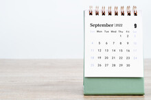 September 2022 Desk Calendar On Wooden Background.