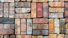 Grunge Background Texture Of Old Worn Colorful Bricks Stacked In Groups Of Three