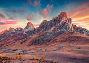 Wall Mural - exciting autumn view from the top of giau pass with famous ra gusela peak on background. amazing sun