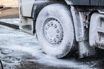 Washing truck wheels with foam solution