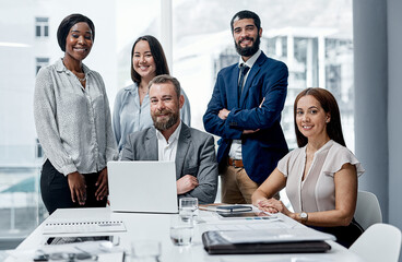 Wall Mural - Teamwork is the best ever investment. Portrait of a group of businesspeople having a meeting in an office.