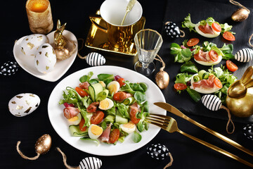 Wall Mural - Easter breakfast with fresh salad and eggs on black table