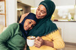© Mediteraneo - Happy muslim mother and daughter spending quality time together at home