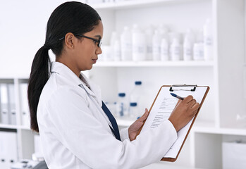 Poster - Filling out some important information. Cropped shot of an attractive young female scientist working on a clipboard in her laboratory.