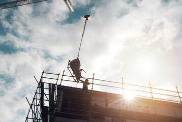 Poster - The more powerful the equipment, the more powerful the finish. Shot of a man lifting heavy machinery with a crane at a building site.