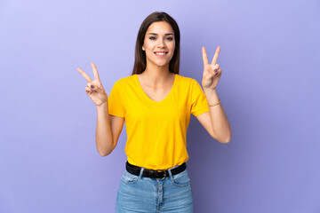 Sticker - Young caucasian woman over isolated background showing victory sign with both hands