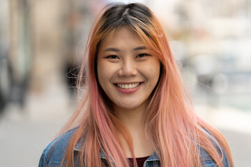 young asian woman with pink hair smile happy face portrait