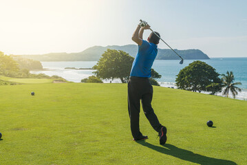 Latin golf instructor teaching the swing in the morning