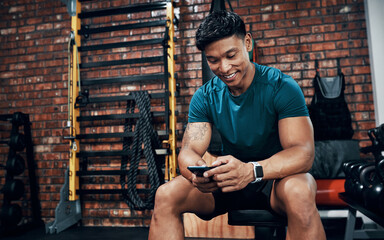 Sticker - This app is like my own personal trainer. Cropped shot of a sporty young man using his cellphone at the gym.