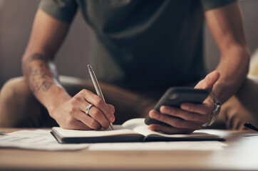 Aufkleber - The best personal finance app on the market. Shot of an unrecognisable man using a smartphone while going through paperwork at home.