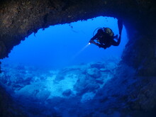 Cave Diving Underwater Scuba Divers Exploring Caves And Having Fun Ocean Scenery Sun Beams And Rays Background