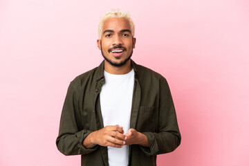 Poster - Young Colombian handsome man isolated on pink background laughing