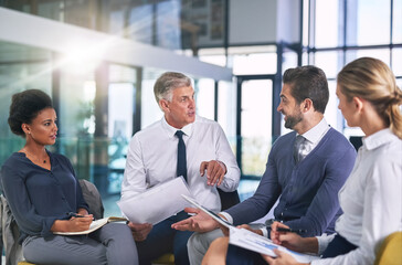 Canvas Print - Engaging in discussion. Cropped shot of a group of businesspeople having a discussion in an office.