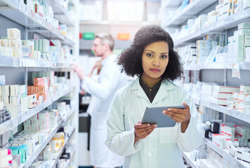 Poster - Its the smartest way to manage a modern pharmacy. Shot of a young woman using a digital tablet to do inventory in a pharmacy.